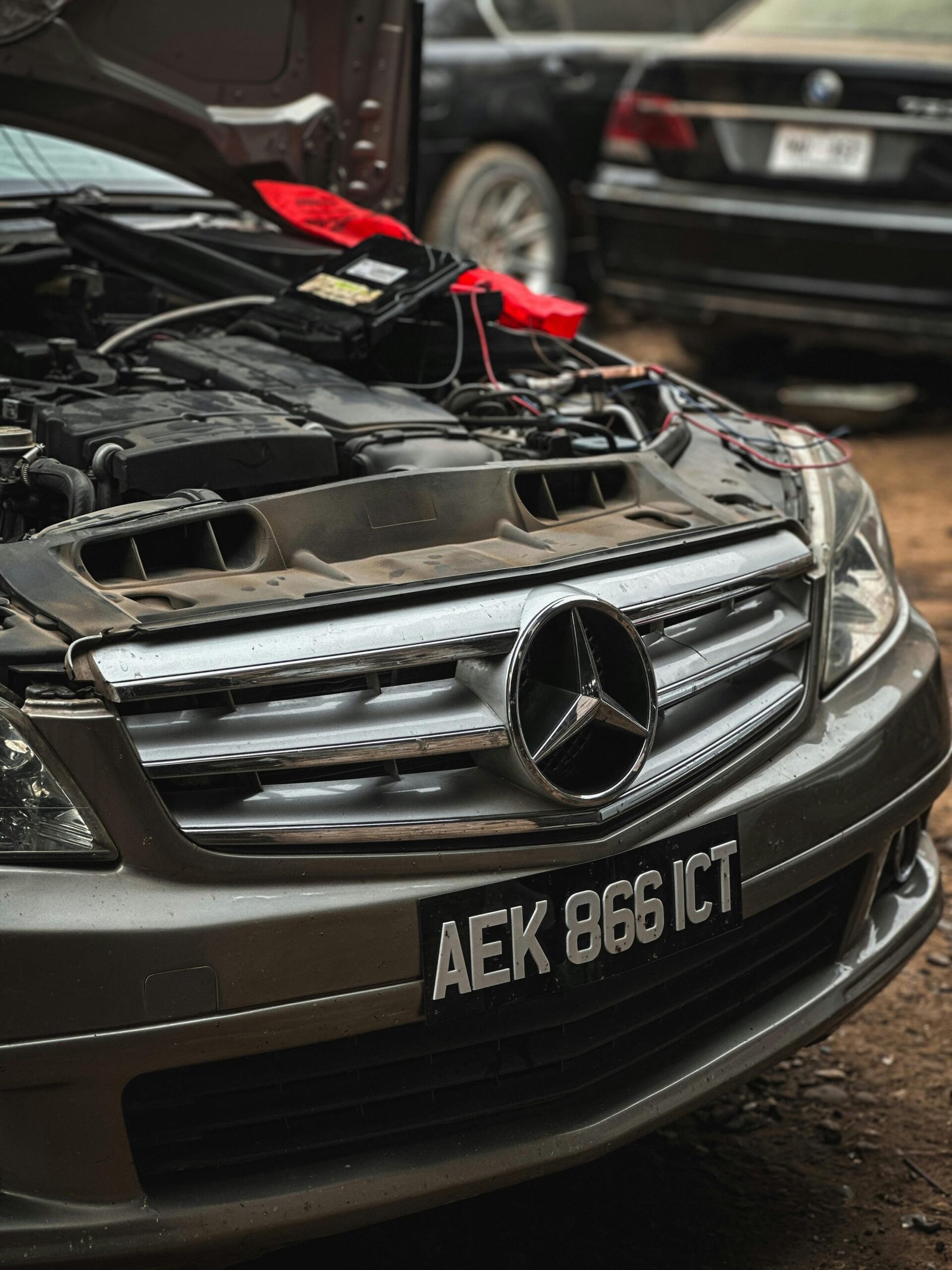 Detailed view of a Mercedes car engine bay with open hood in Peshawar, Pakistan.
